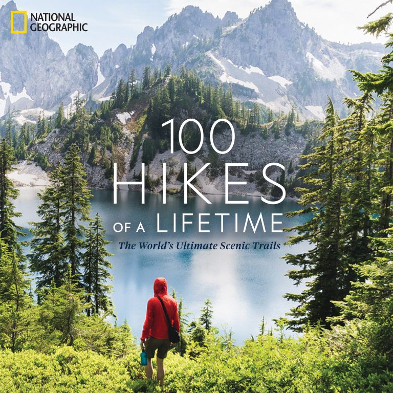 Cover of National Geographic 100 Hikes of a Lifetime: The World's Ultimate Scenic Trails, showing a hiker in a red jacket overlooking an alpine lake